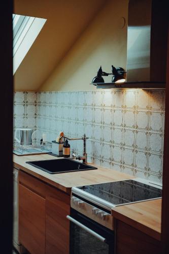 a kitchen with a sink and a stove at Haus am Weiher in Schwangau
