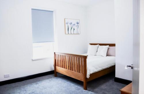 a bedroom with a bed and a window at Cosy Luxe Manchester Home With Fresh Bakes in Manchester