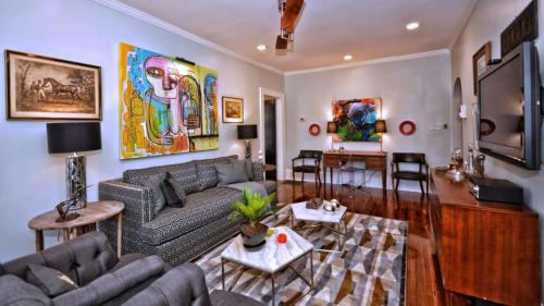 a living room with a couch and a table at The Home Collection CLT: 500 Queens in Charlotte
