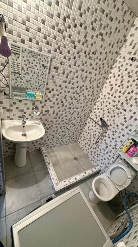 a small bathroom with a sink and a toilet at Holiday house Tbilisi in Tbilisi City