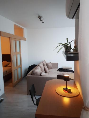 a living room with a table and a couch at Apartmán Centrum in Šamorín