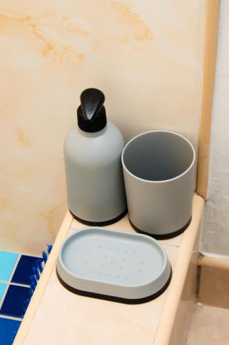 a scale sitting on a shelf next to a cup at Tasha Coastal Accommodation in Walvis Bay