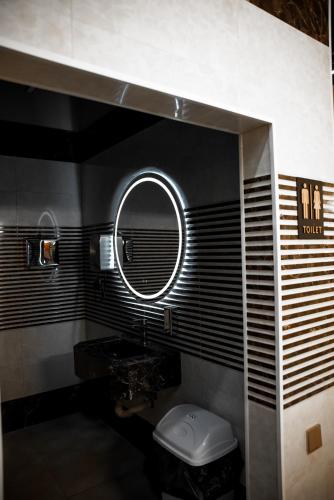 a bathroom with a sink and a mirror at LIFESPORT-Complex Hotel & spa in Əlǝt