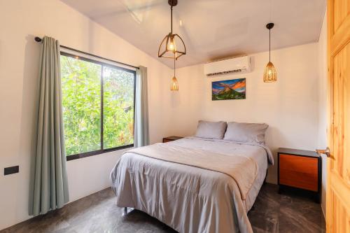 En eller flere senge i et værelse på Villa Tucán Fortuna