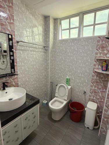 a bathroom with a toilet and a sink at AJ Homestay Muar in Muar