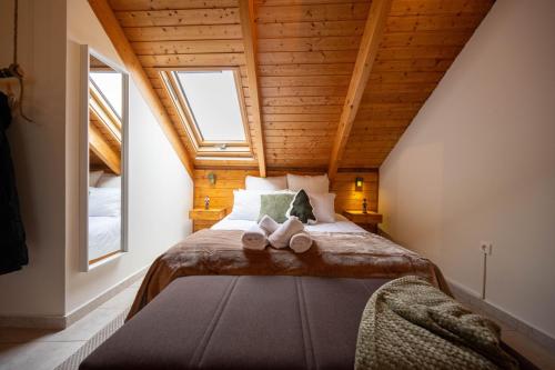 a bedroom with a bed with two slippers on it at Rokani Sofita II in Kalavrita