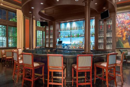 a bar in a restaurant with chairs around it at The George Washington - A Wyndham Grand Hotel in Winchester