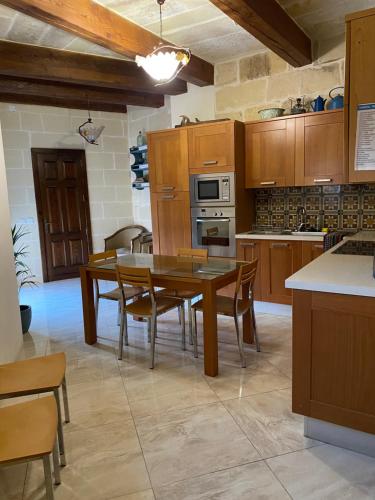 a kitchen with a table and chairs in a kitchen at St Therese in Victoria