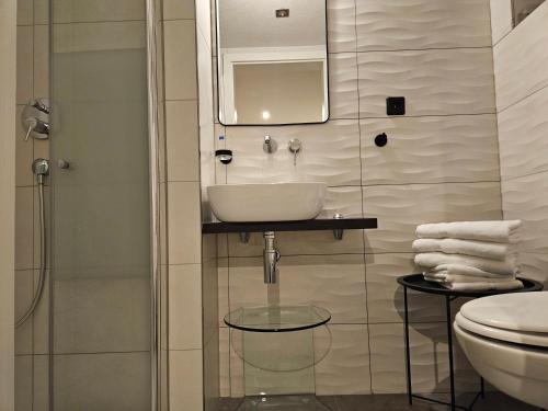 a bathroom with a sink and a toilet at Ferienwohnung Zur Alt Ave in Deggingen