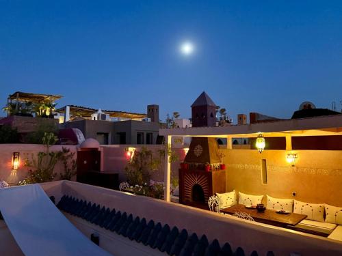 a view from the roof of a building at night at Riad Ta'achchaqa in Marrakech