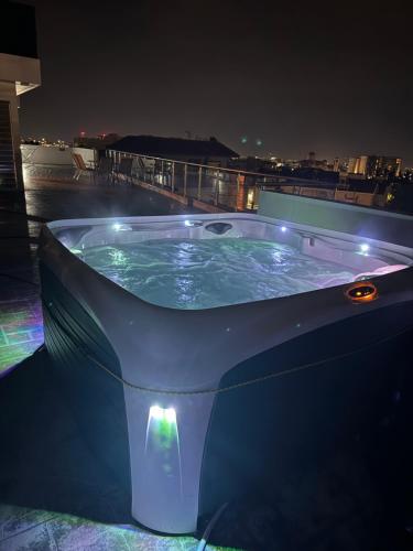 a jacuzzi tub on a rooftop at night at Penthouse with outdoor hottub in Limassol