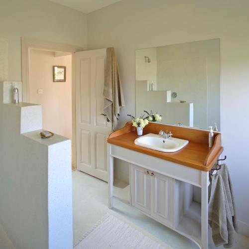 a bathroom with a sink and a mirror at Soames Hotel & Jack' s Bar in Nanyuki