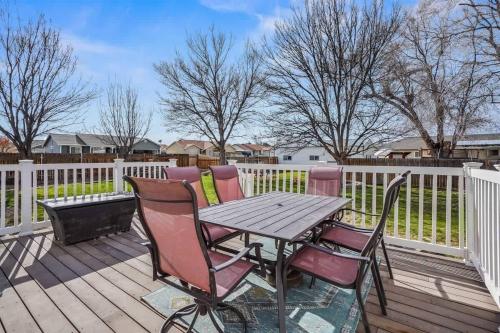 a wooden deck with a wooden table and chairs at Haven Oasis in Nampa