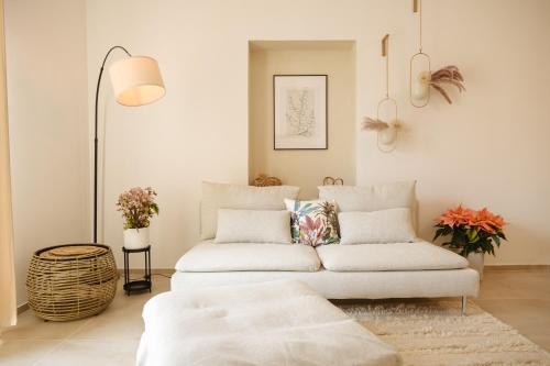 a living room with a white couch and a table at Casa Dante in Putignano