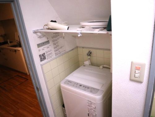 a white washer and dryer in a kitchen at Green House 大阪 in Osaka
