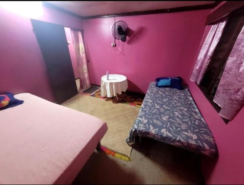 a small room with two beds and a table at Surf stay cloudbreak in Nadi