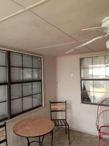 a room with a table and chairs and windows at Home Away in Grand Prairie