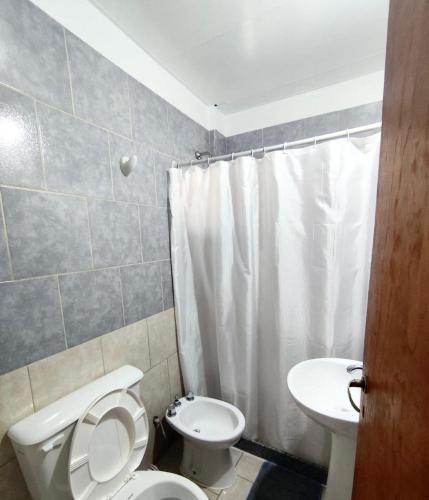 a bathroom with a toilet and a sink at Gotas de Rocio N1 in San Antonio Oeste