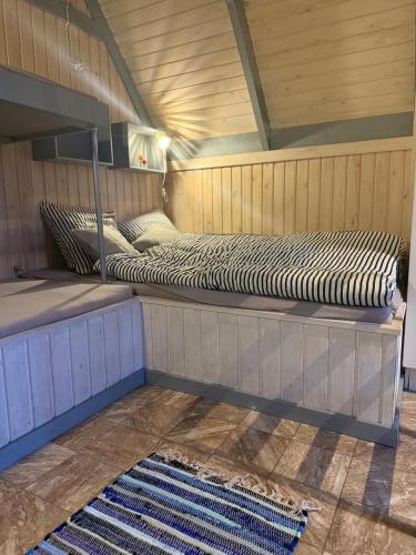 two beds sitting on a platform in a room at Bovbjerg Camping in Lemvig