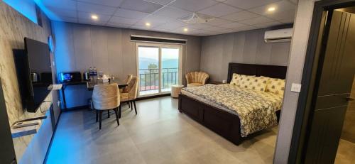 a bedroom with a bed and a table with chairs at LvL 50 in Murree