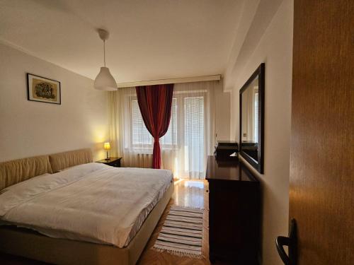 a bedroom with a large bed and a window at Premium 1 One bedroom apartment Maksim Gorki street 8 in Skopje