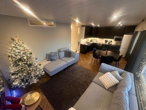 a living room with a christmas tree and a couch at Apartment Alakorkalo in Rovaniemi