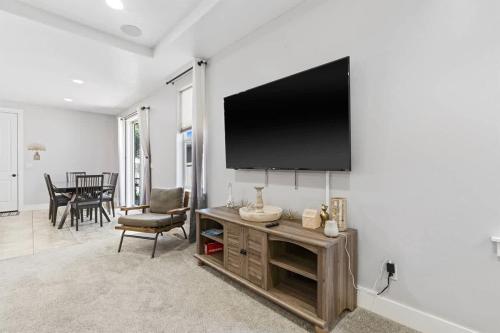 a living room with a large flat screen tv on a wall at Sensible Safari Sleeps 10 in Meridian