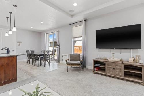 a living room with a flat screen tv on a wall at Sensible Safari Sleeps 10 in Meridian