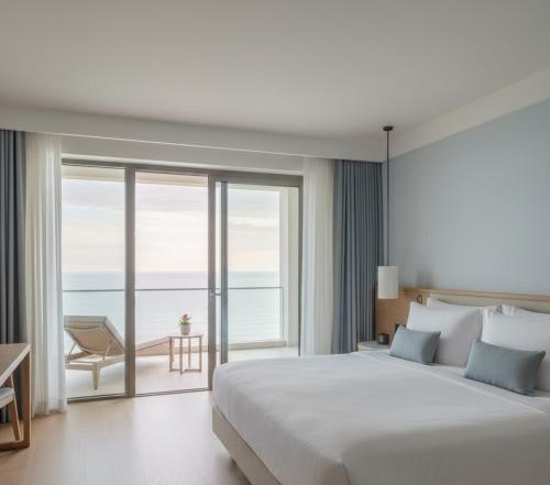 una camera con un grande letto e una vista sull'oceano di Takes Antalya Luxury Hotel a Antalya (Adalia)