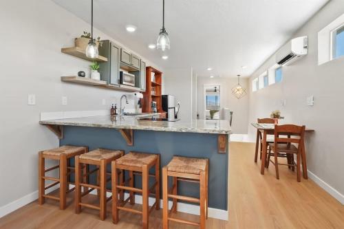 a kitchen with a large island with stools at Caldwell Cliff Swallow Guest House in Caldwell
