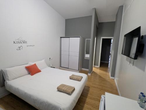 a bedroom with a white bed with two pillows on it at "Habitaciones Confort La Cuesta" in Las Lagunas