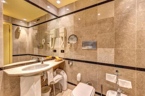 a bathroom with a sink and a toilet at Hotel Motel Regal in Vermezzo