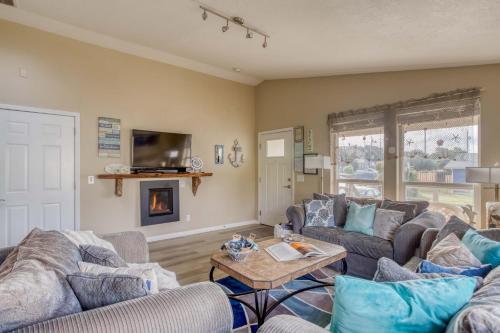 a living room with two couches and a fireplace at Beachy Keen in Lincoln City