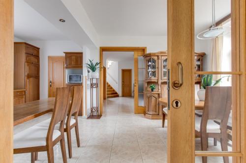 a kitchen and dining room with a table and chairs at Vila Adalbert in Liberec