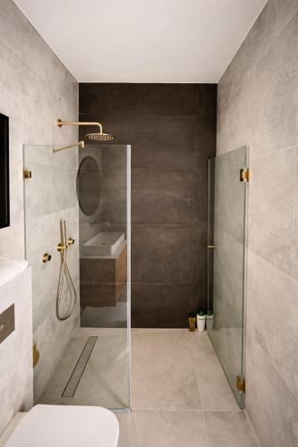 a bathroom with a shower and a sink at Luxury Point TLV in Giv‘atayim