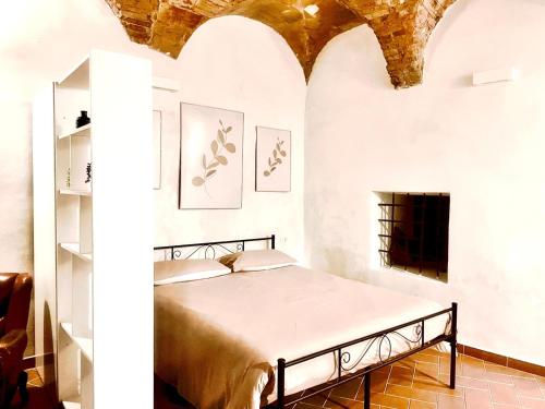 a bedroom with a bed in a room with a fireplace at Casa "La Fonte" in Spoleto