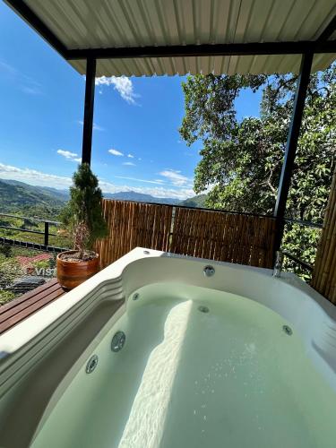 a bath tub with a view of the mountains at Bellavista La Vega in La Vega
