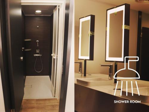 a bathroom with two sinks and a shower room at Calendar Hotel in Otsu