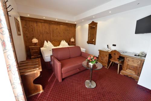 a hotel room with a couch and a bed at Hotel Coellner Hof in Cologne