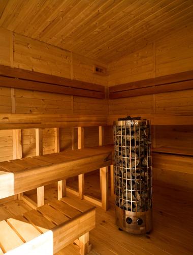 an inside of a wooden sauna with a wine rack at Can Pardis in Cala Llonga