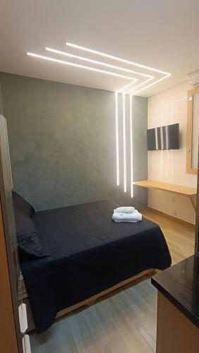 En eller flere senge i et værelse på Studio moderno no centro de São Lourenço Avenida Principal