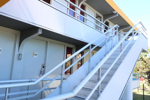 a stairway leading up to a balcony at Premiere Classe Agen in Agen