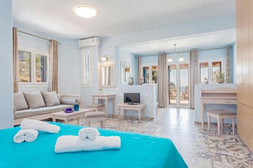 a living room with a blue bed and a couch at Stafylos Suites & Boutique hotel in Stafylos
