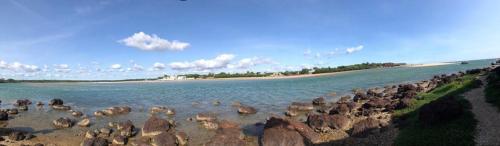 a group of birds standing in the water near a beach at Villa Amani in Somone