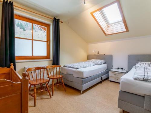 een slaapkamer met twee bedden en een tafel en stoelen bij Fintinn in Hüttschlag