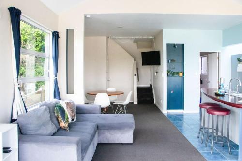 a living room with a couch and a table at Comfort in Khandallah in Wellington