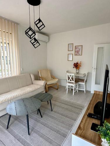 a living room with a couch and a table at Apartment DUNJA 2 Laktasi in Laktaši
