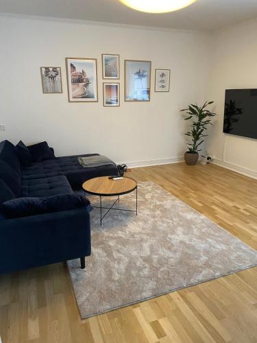 a living room with a blue couch and a table at Lovely apartment in Vejle C in Vejle
