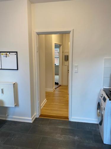 a hallway with a door leading to a laundry room at Lovely apartment in Vejle C in Vejle