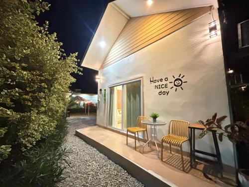 a house with a table and chairs outside at night at บ้านสวนโอเชี่ยน Ocean Garden Home in Chiang Khan